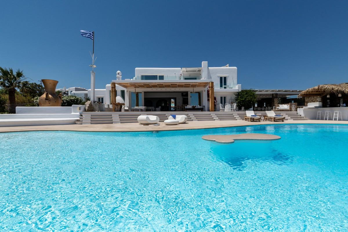 Top 5 Mykonos Villa Rentals - View of the pool and a villa in Mykonos behind it