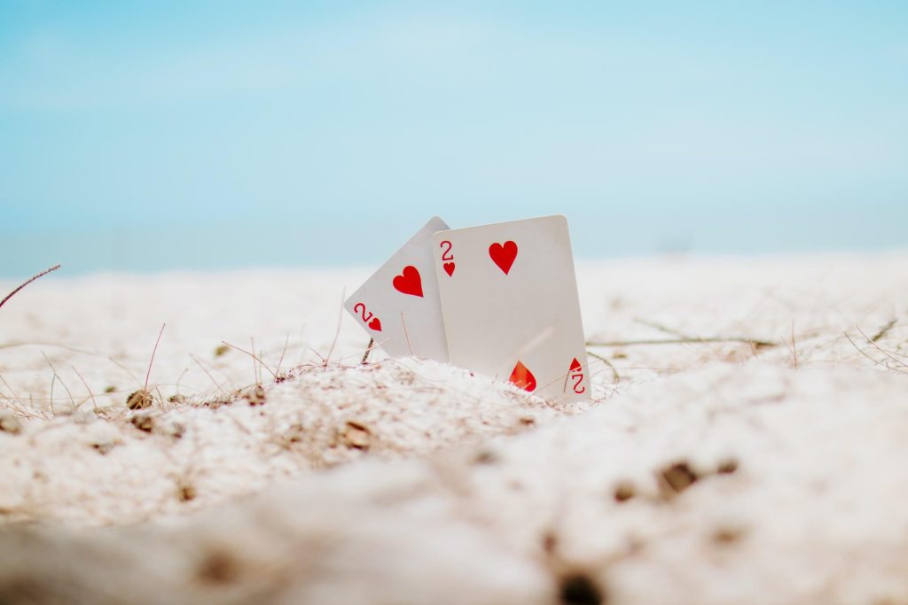 Two cards in the sand